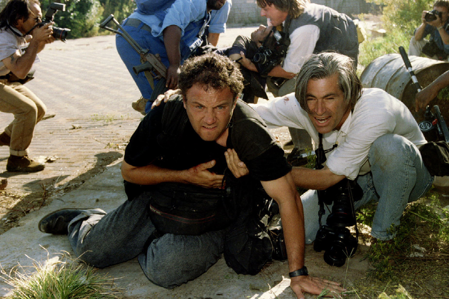 SOUTH AFRICAN PHOTOGRAPHER MARINOVICH IS HELPED TO COVER BY US COLLEAGUE NATCHWEY