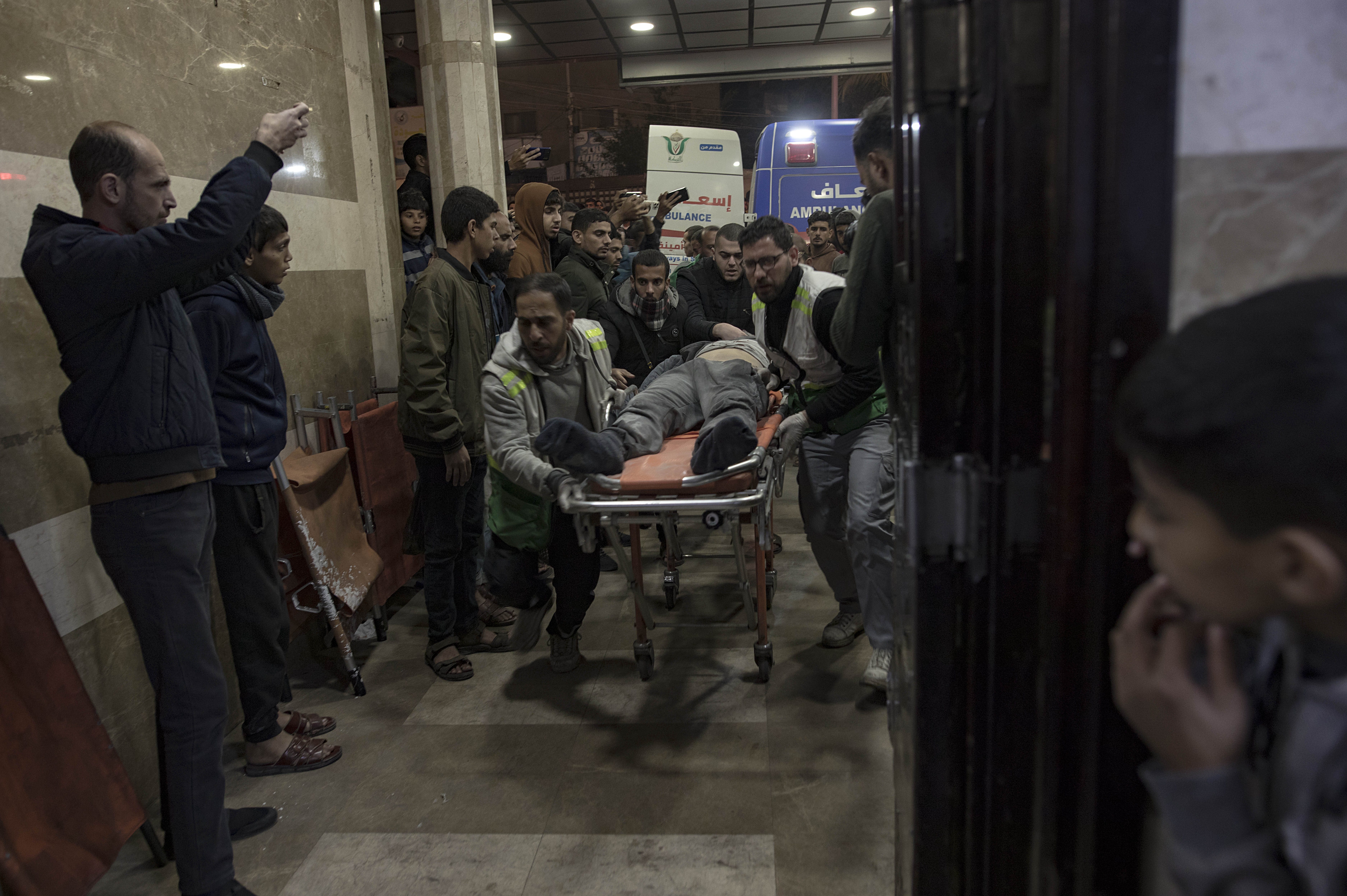 An injured man is rushed to Nasser Hospital in Khan Younis following Israeli air raids