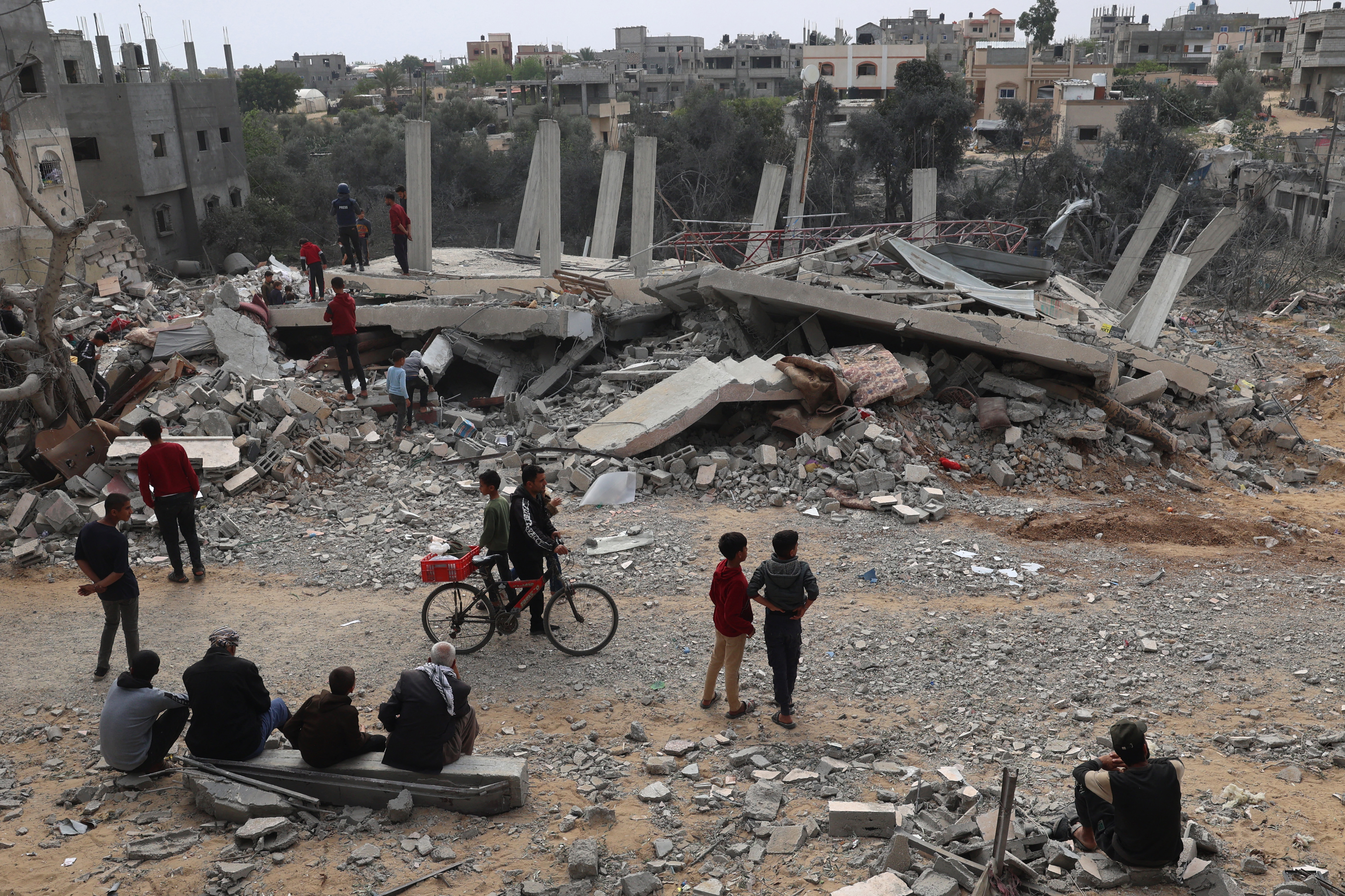 Palestinians inspect the damage to a building after overnight Israeli bombardment in Rafah in the southern Gaza Strip on March 29, 2024, amid the ongoing conflict between Israel and the militant group Hamas. (Photo by SAID KHATIB / AFP)