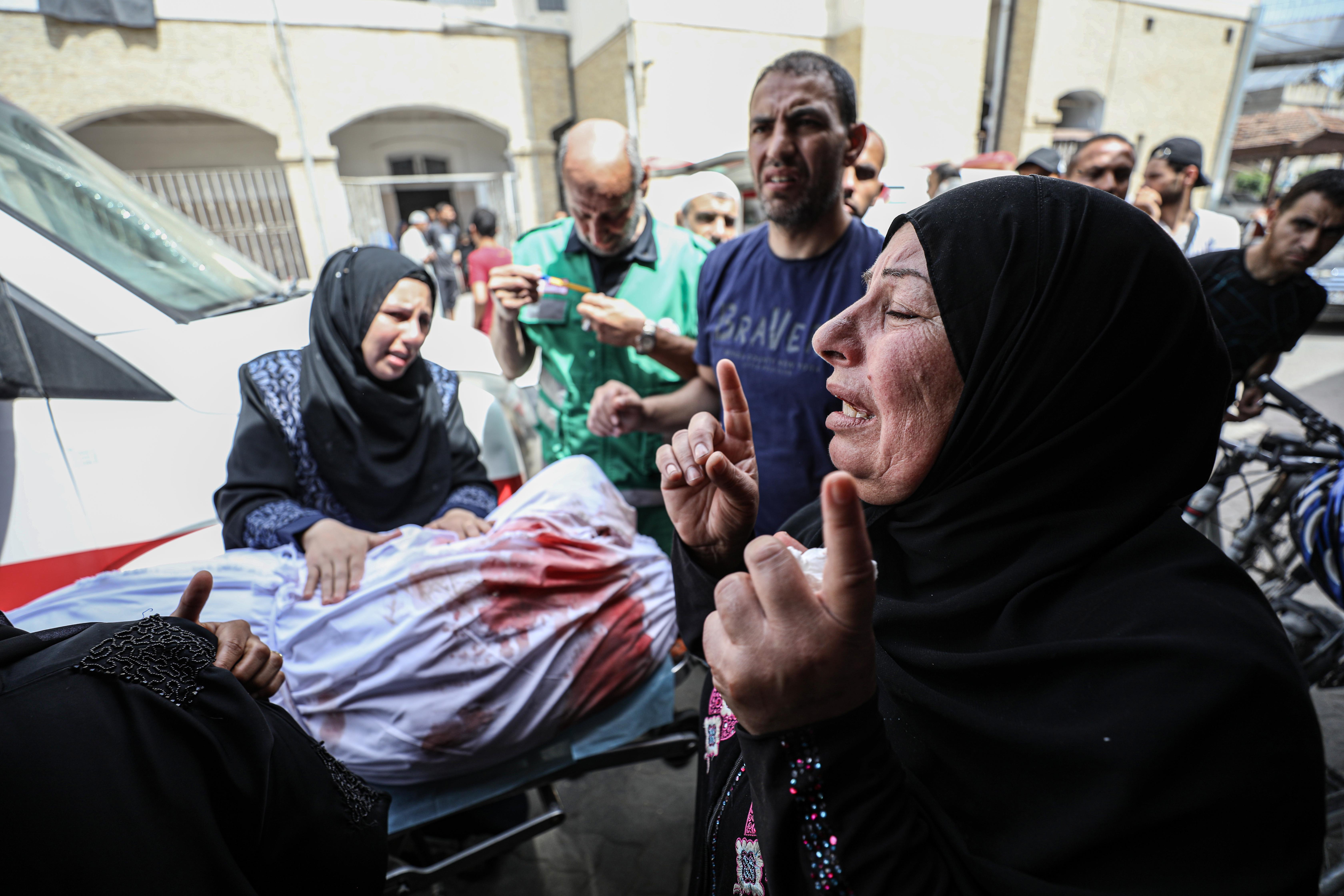A woman mourns as bodies of Palestinians, died following the Israeli attacks on Jibaliya and Beit Lahia,