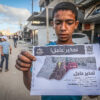Palestinian boy holding a leaflet dropped by the Israeli army ordering residents to evacuate the Bani Suhaila and Abasan areas in eastern Khan Younis, in the southern Gaza Strip, May 19, 2025 (Abed Rahim Khatib/Flash90)
